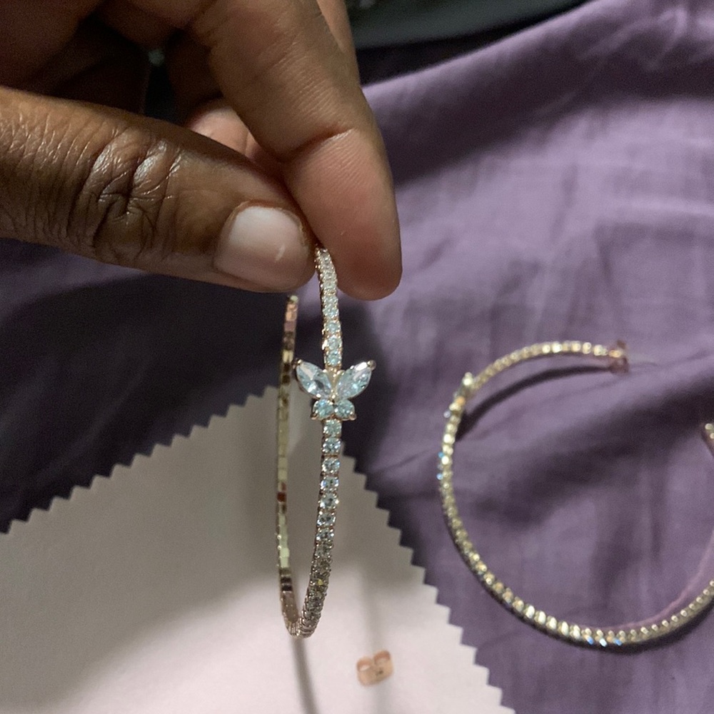 Med size hoop earrings butterfly on it